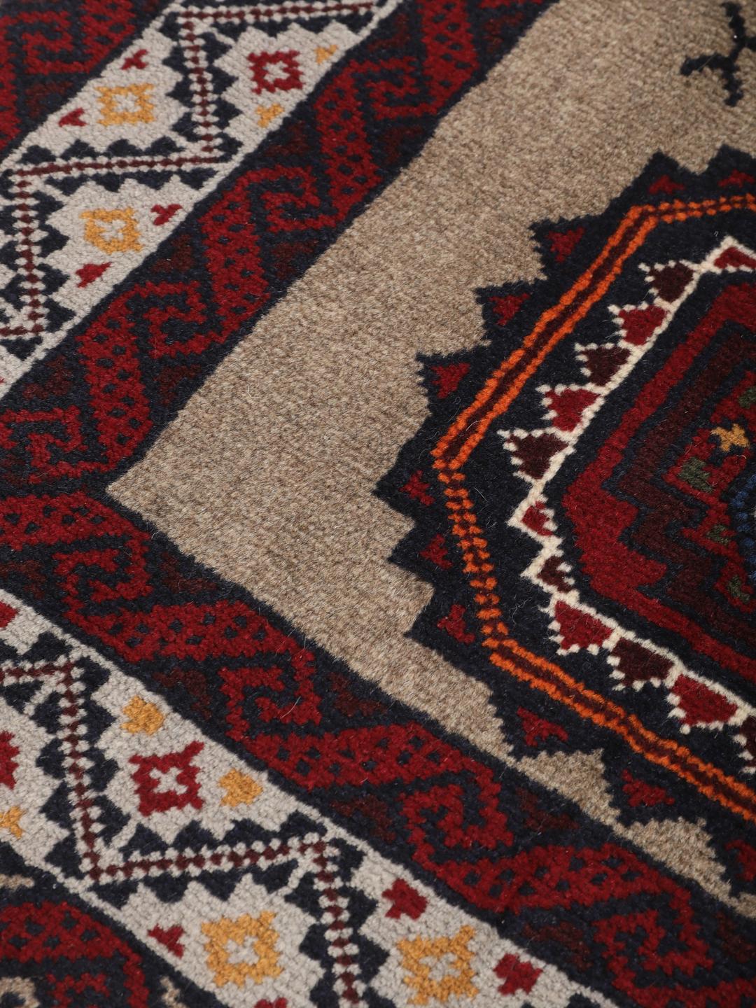 Hand-knotted Middle Eastern Baluch rug in red and beige tones