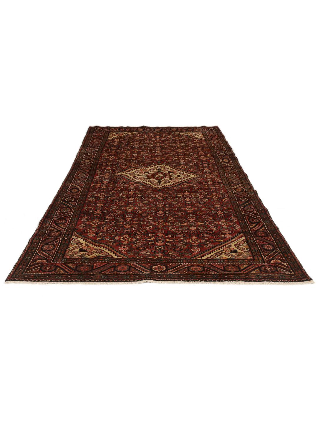 Een handgeknoopt donkerrood Hosseinabad-tapijt met ingewikkelde geometrische patronen.
