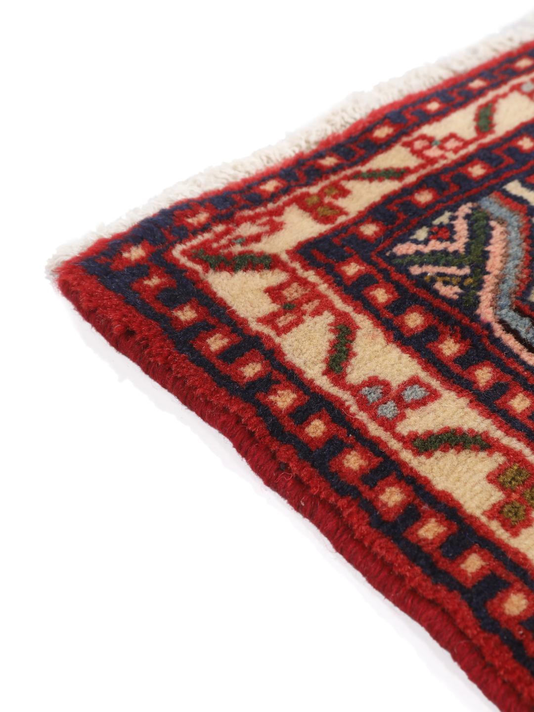 Hand-knotted Asadabad rug from the Middle East with a vibrant red field and geometric patterns
