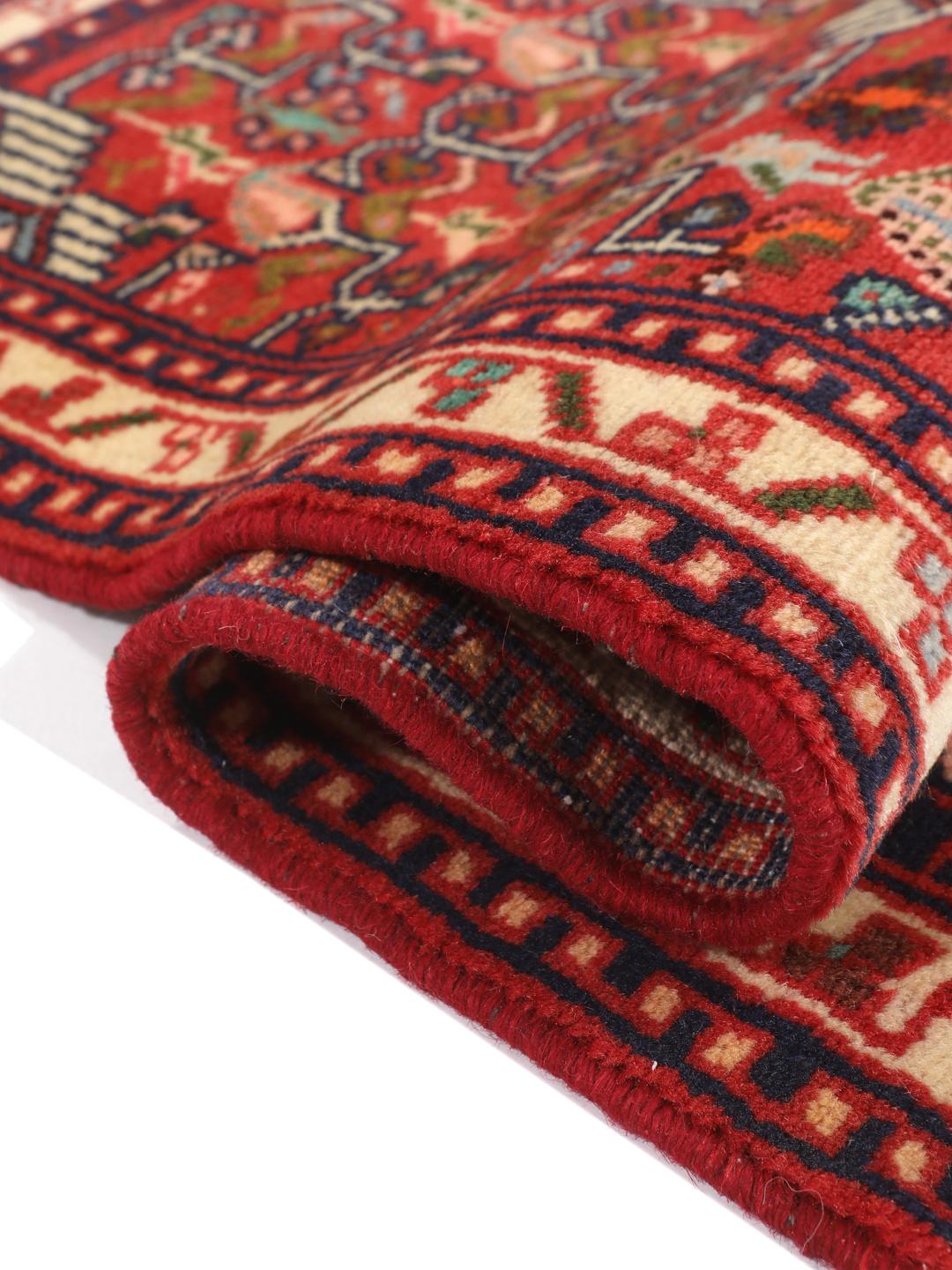Hand-knotted Asadabad rug from the Middle East with a vibrant red field and geometric patterns