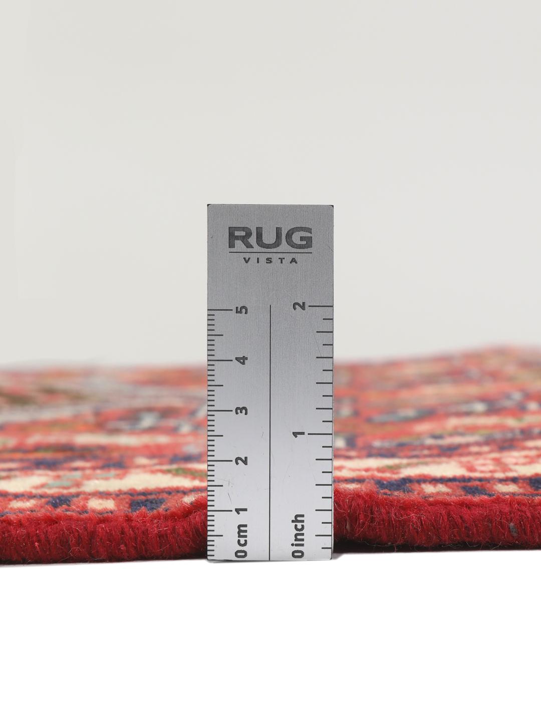 Hand-knotted Asadabad rug from the Middle East with a vibrant red field and geometric patterns