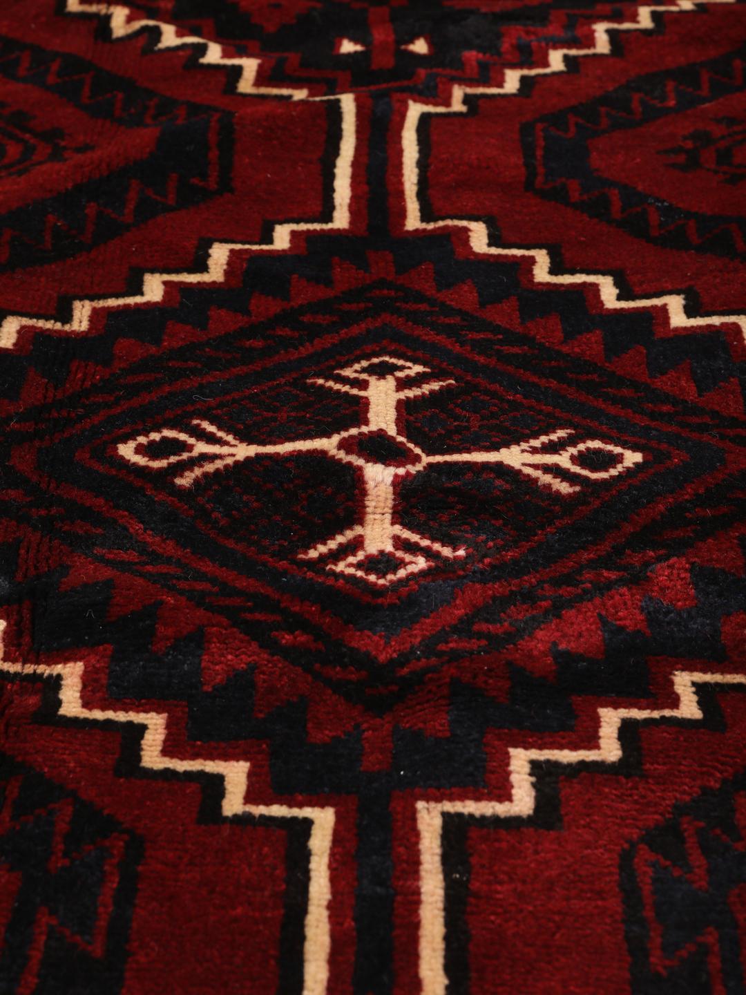 Hand-knotted Lori rug from the Middle East in dark red tones