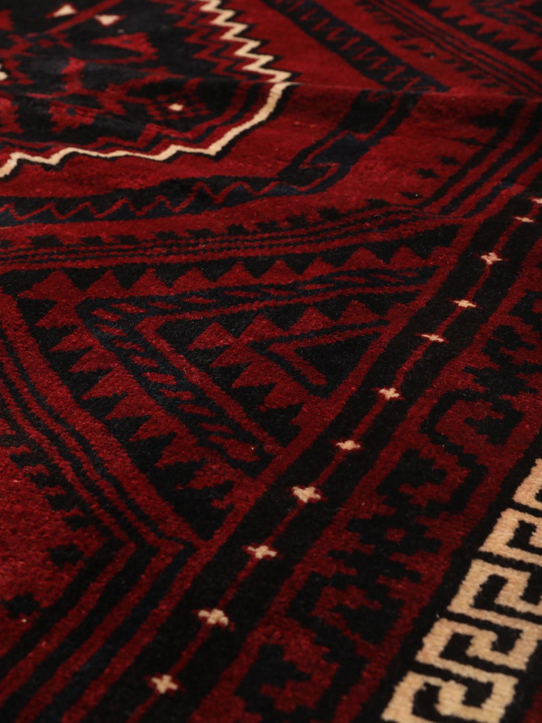 Hand-knotted Lori rug from the Middle East in dark red tones