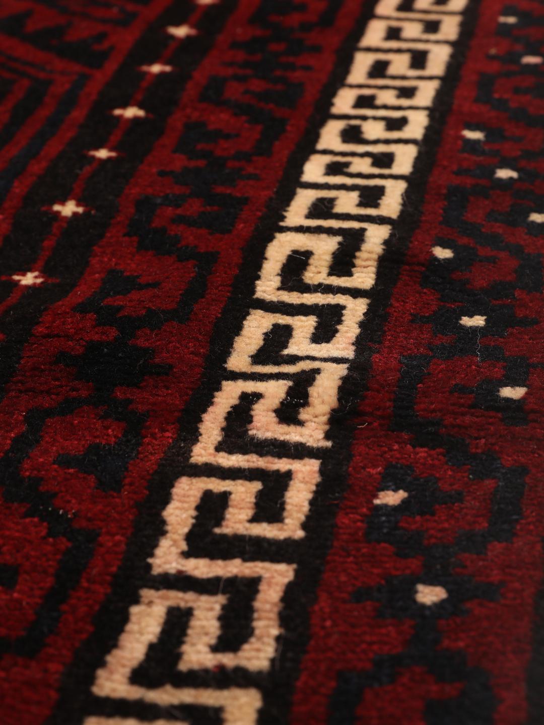 Hand-knotted Lori rug from the Middle East in dark red tones