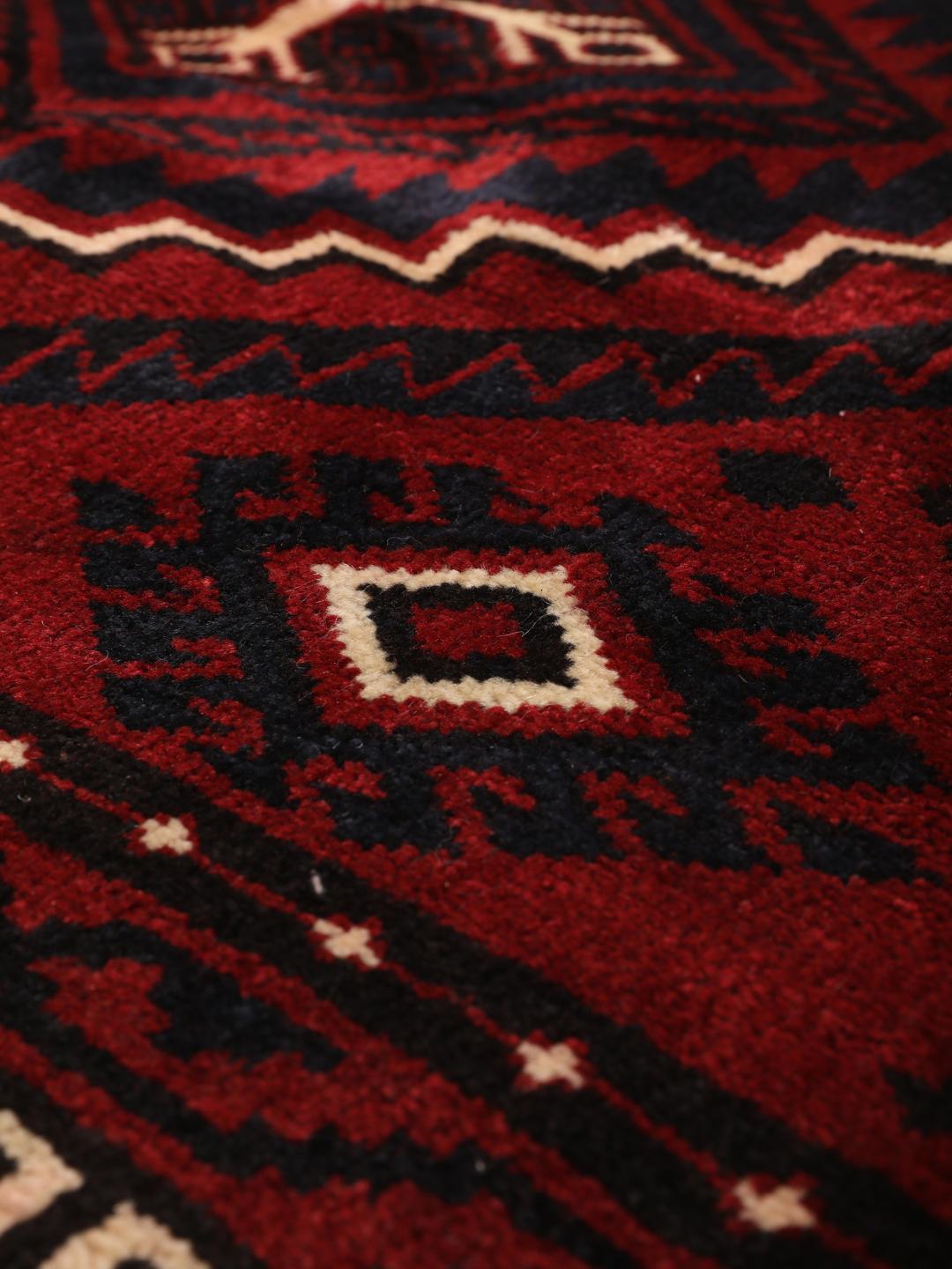 Hand-knotted Lori rug from the Middle East in dark red tones