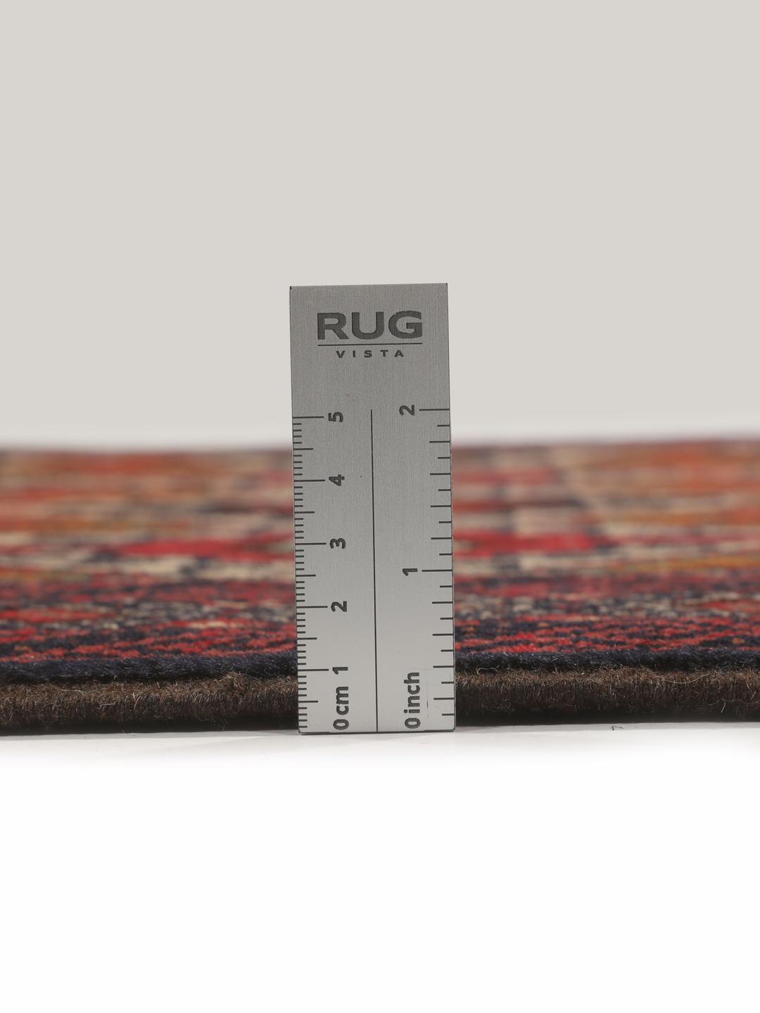 Hand-knotted Baluch rug from the Middle East in deep red and black tones