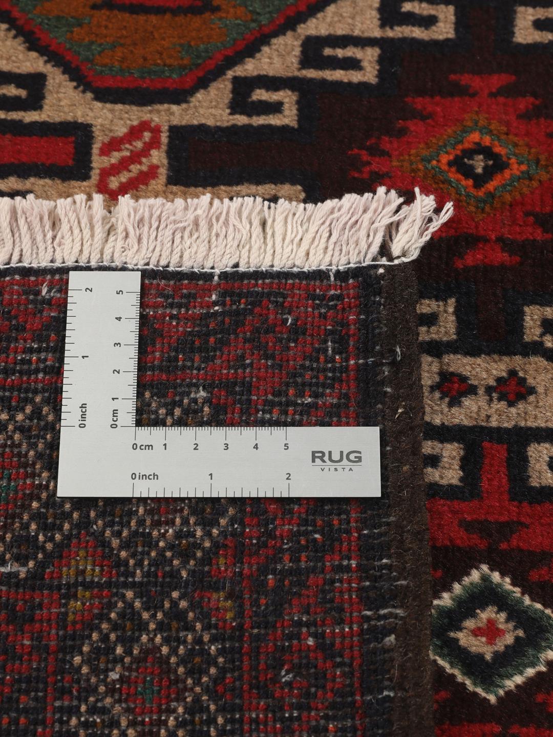 Hand-knotted Baluch rug from the Middle East in deep red and black tones