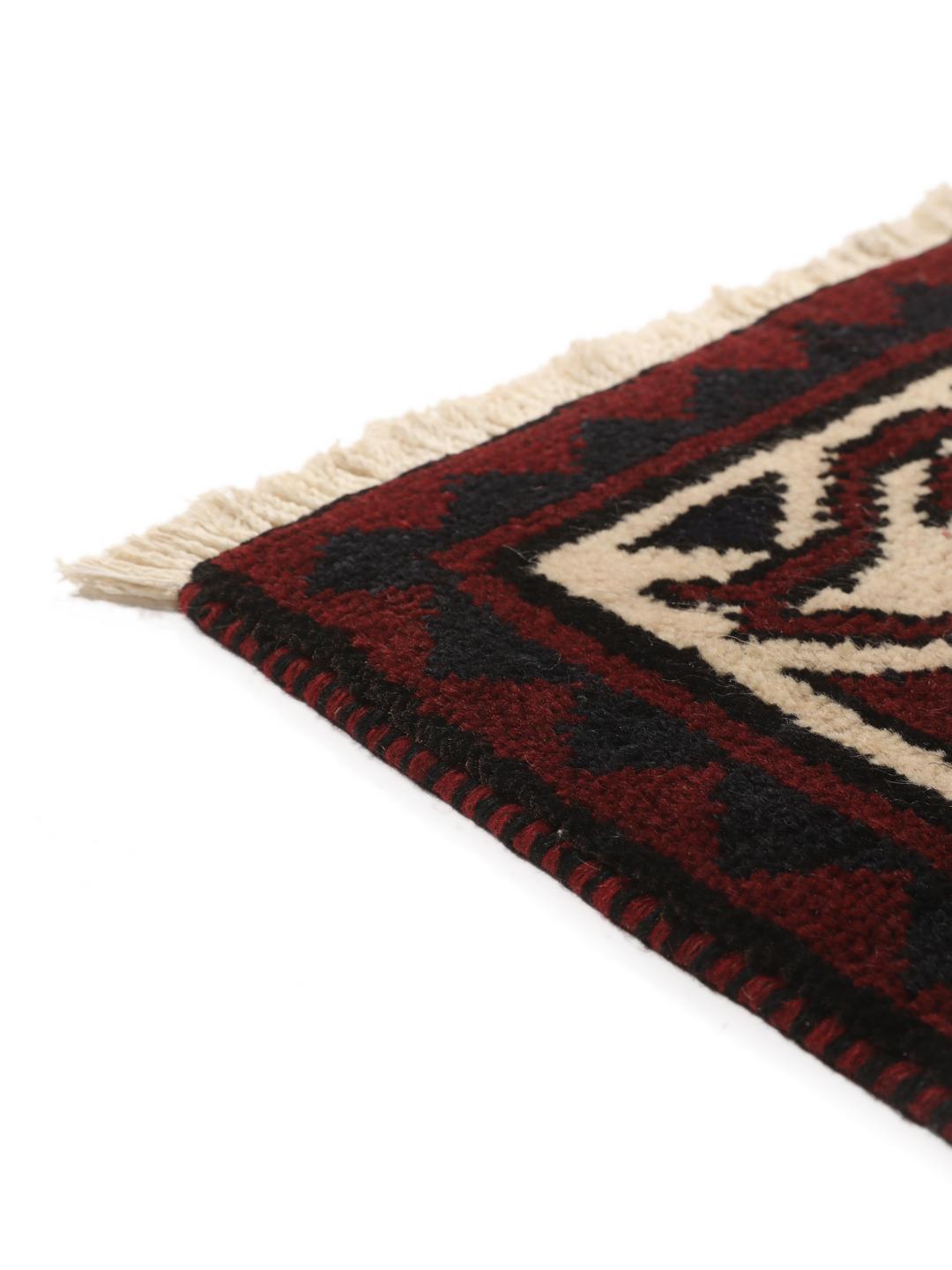 A hand-knotted Lori rug from the Middle East featuring a dark-red and black geometric pattern.