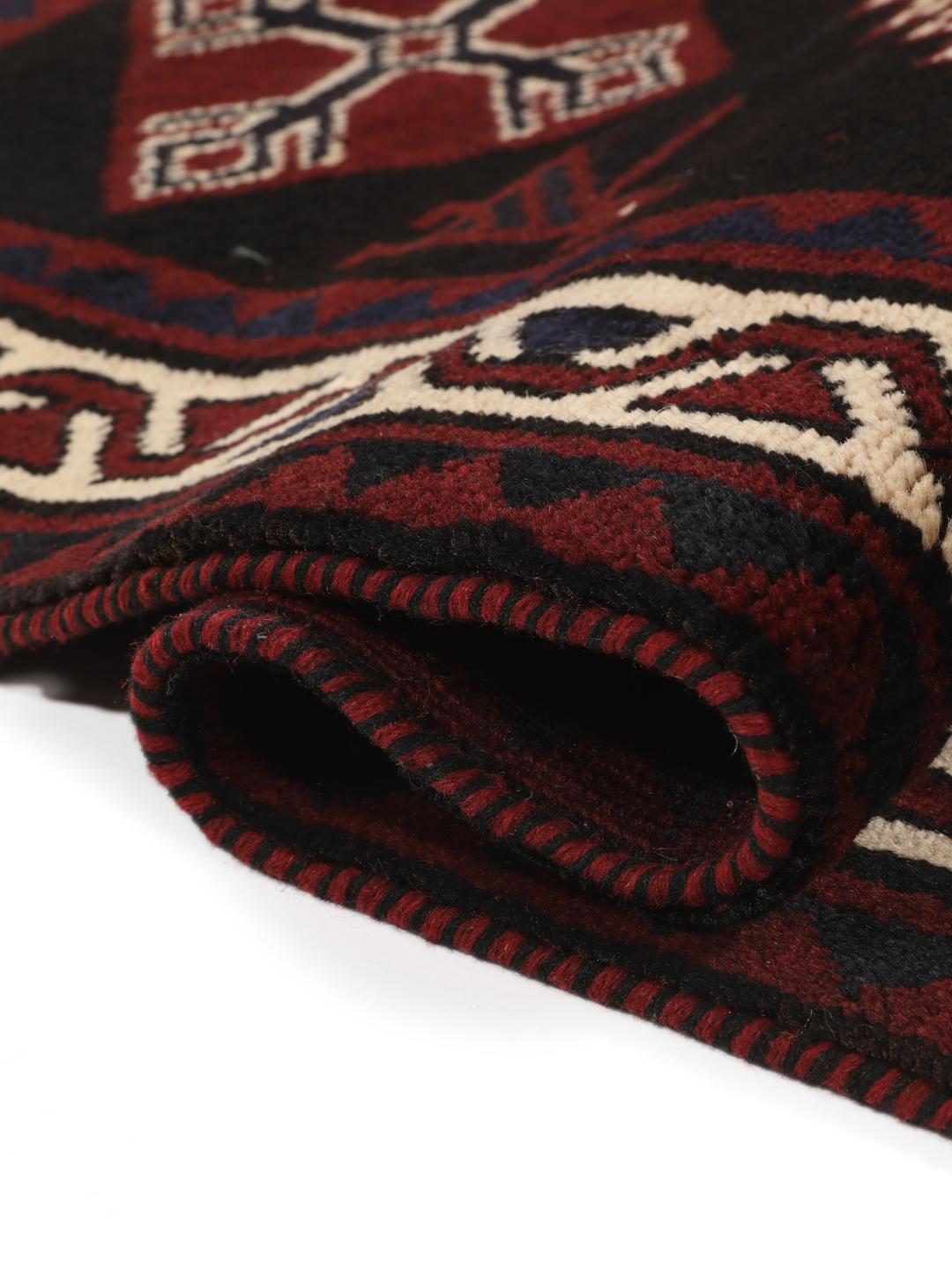 A hand-knotted Lori rug from the Middle East featuring a dark-red and black geometric pattern.