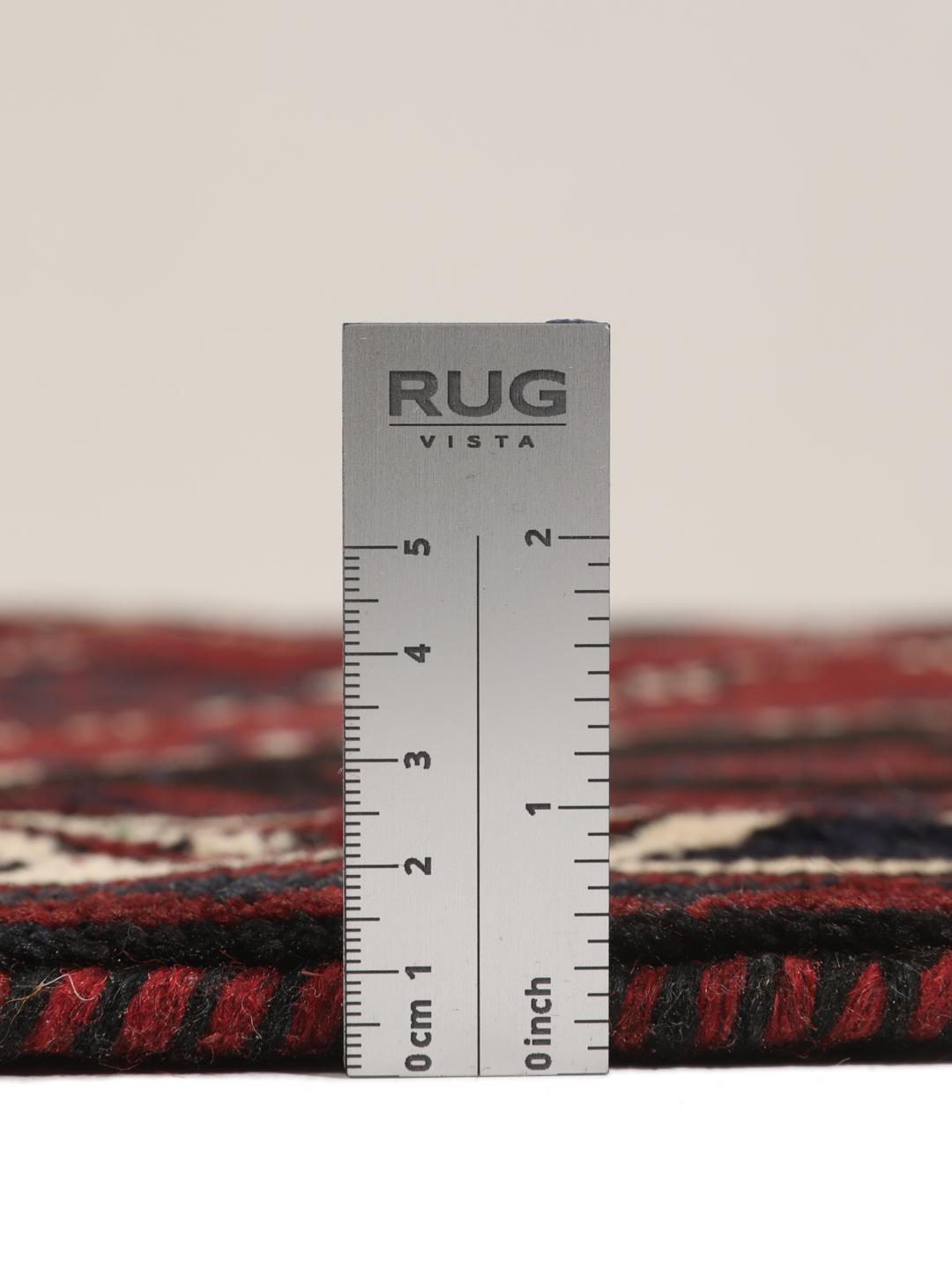 A hand-knotted Lori rug from the Middle East featuring a dark-red and black geometric pattern.