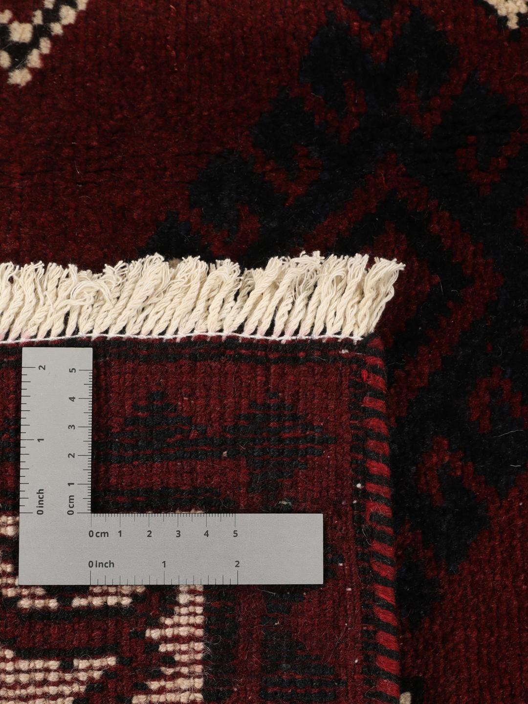 A hand-knotted Lori rug from the Middle East featuring a dark-red and black geometric pattern.