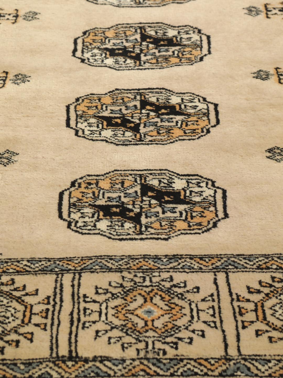 Hand-knotted Pakistan Bokhara rug with beige background and medallion patterns