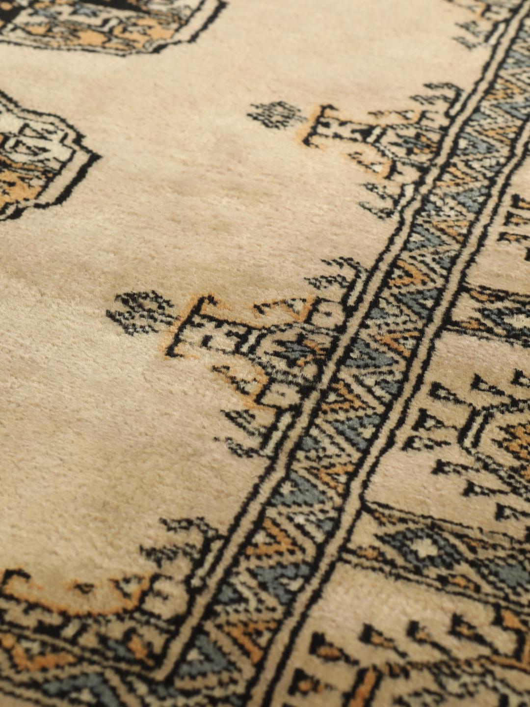 Hand-knotted Pakistan Bokhara rug with beige background and medallion patterns