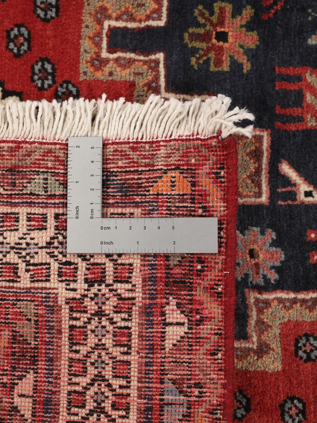 Hand-knotted Afshar rug from the Middle East featuring a red and blue field with tribal animal motifs.