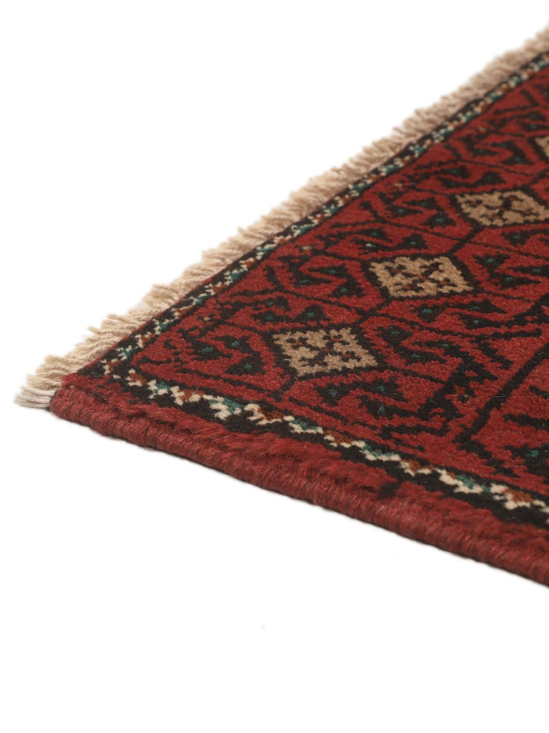 Hand-knotted Beluch rug from the Middle East in dark-red and beige