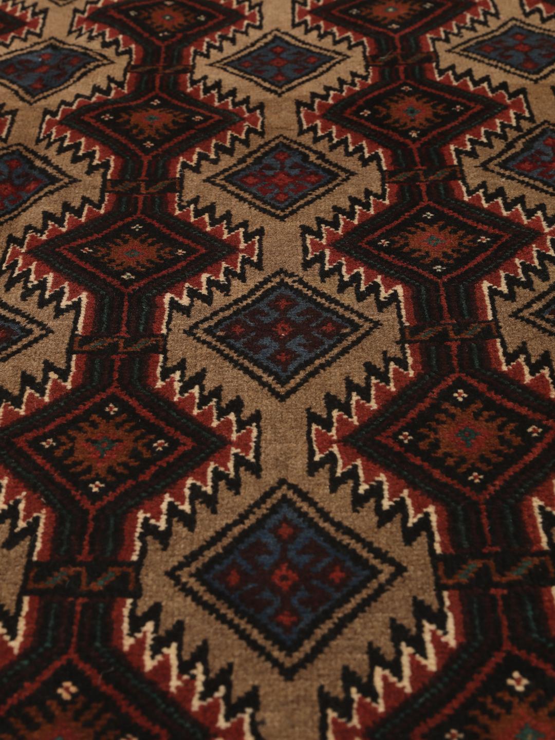Hand-knotted Beluch rug from the Middle East in dark-red and beige