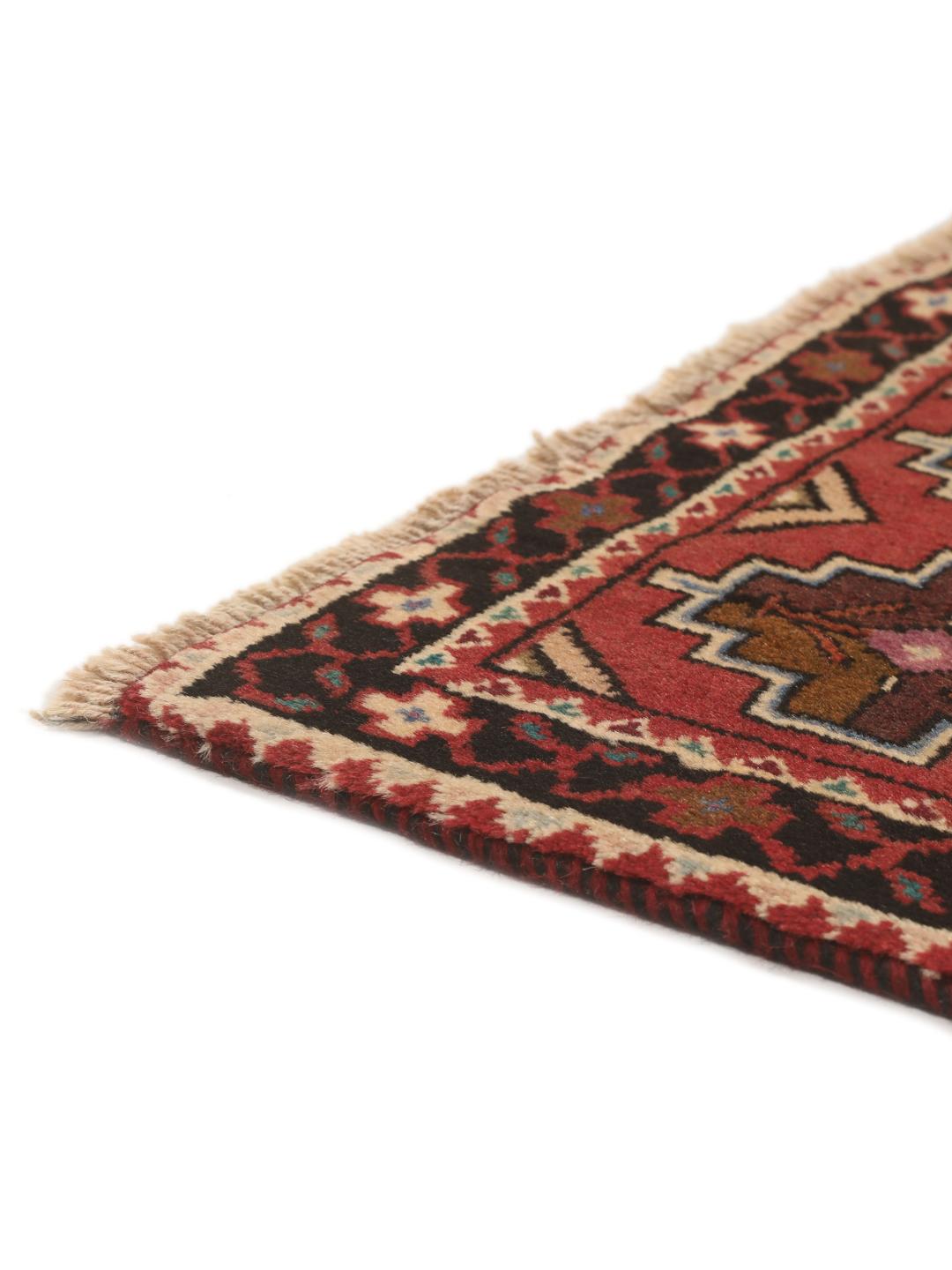 Hand knotted Baluch rug from the Middle East in dark-red with geometric motifs