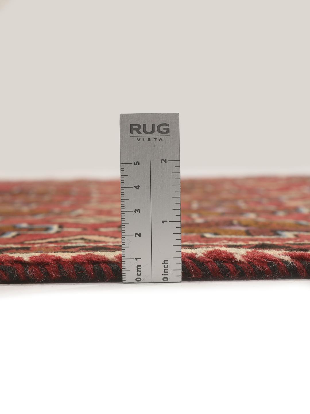 Hand knotted Baluch rug from the Middle East in dark-red with geometric motifs