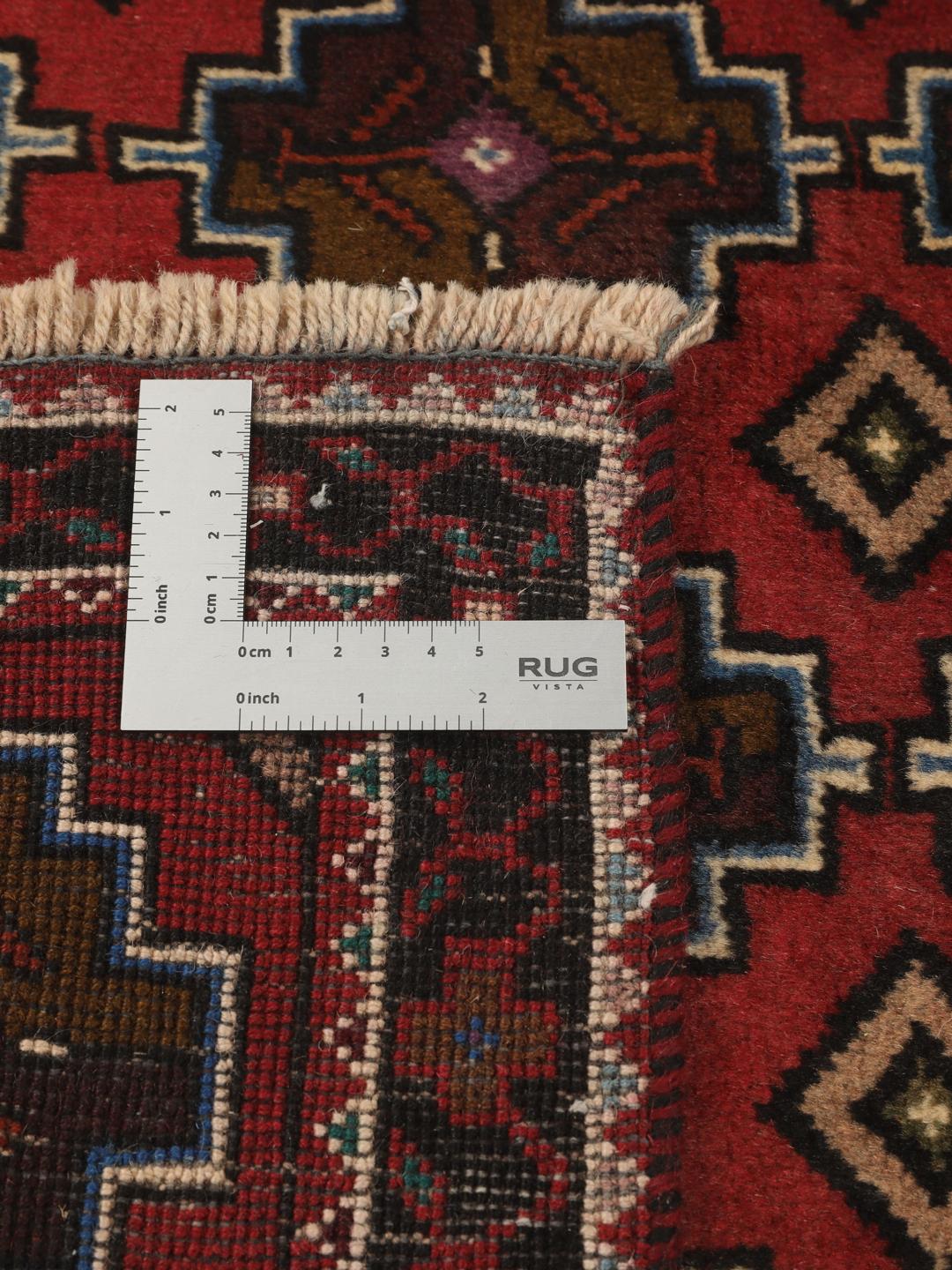 Hand knotted Baluch rug from the Middle East in dark-red with geometric motifs