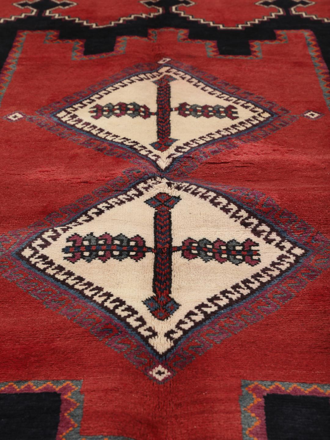 Hand-knotted Afshar rug from the Middle East in red with geometric patterns