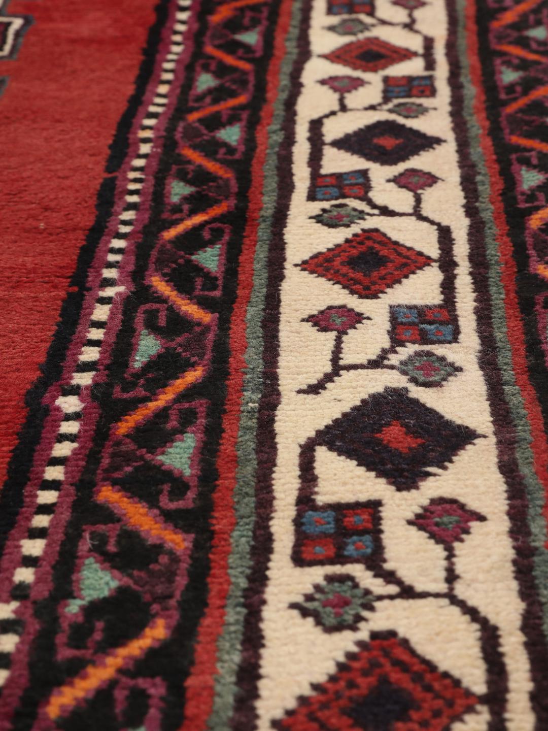 Hand-knotted Afshar rug from the Middle East in red with geometric patterns