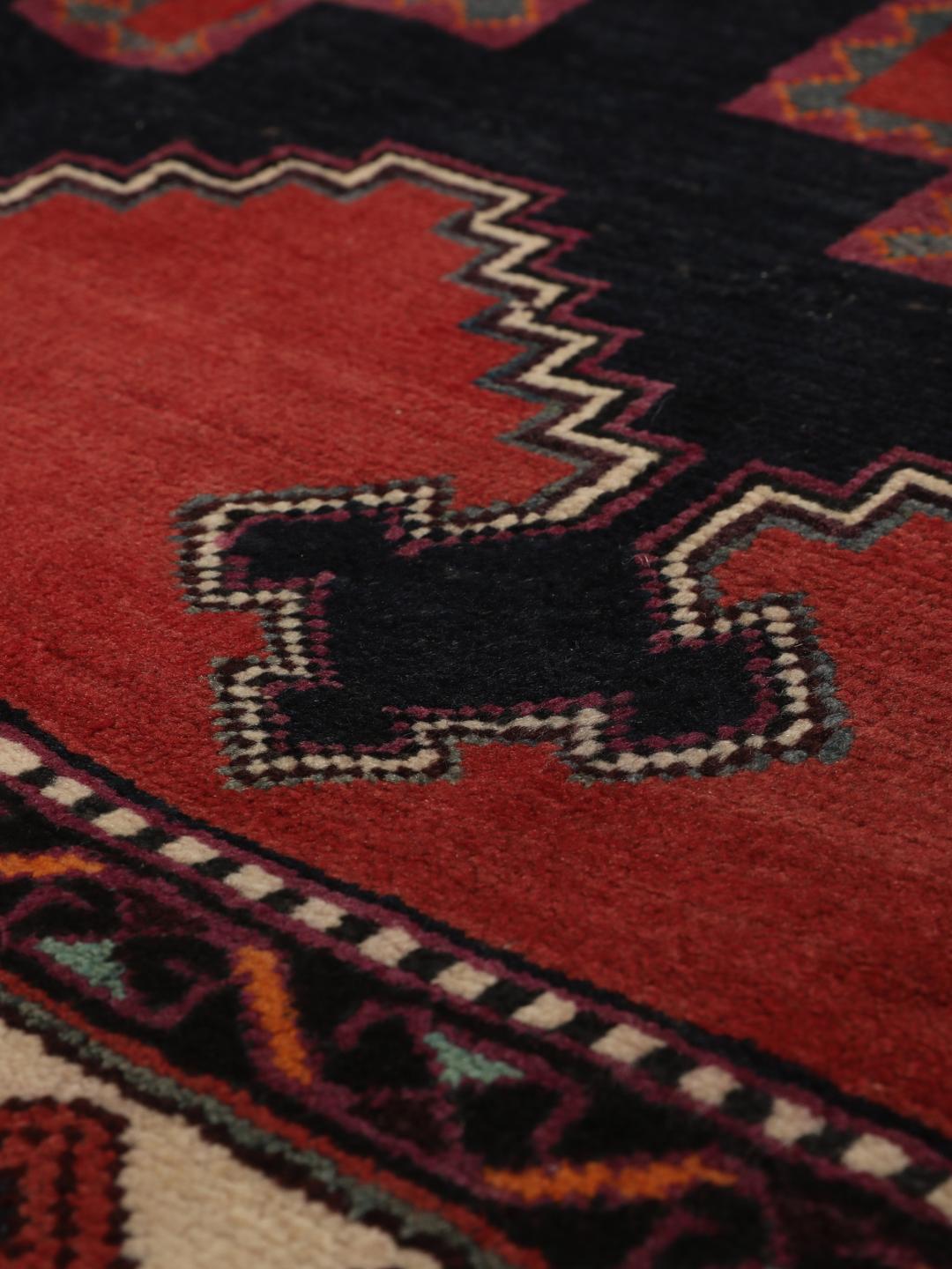 Hand-knotted Afshar rug from the Middle East in red with geometric patterns