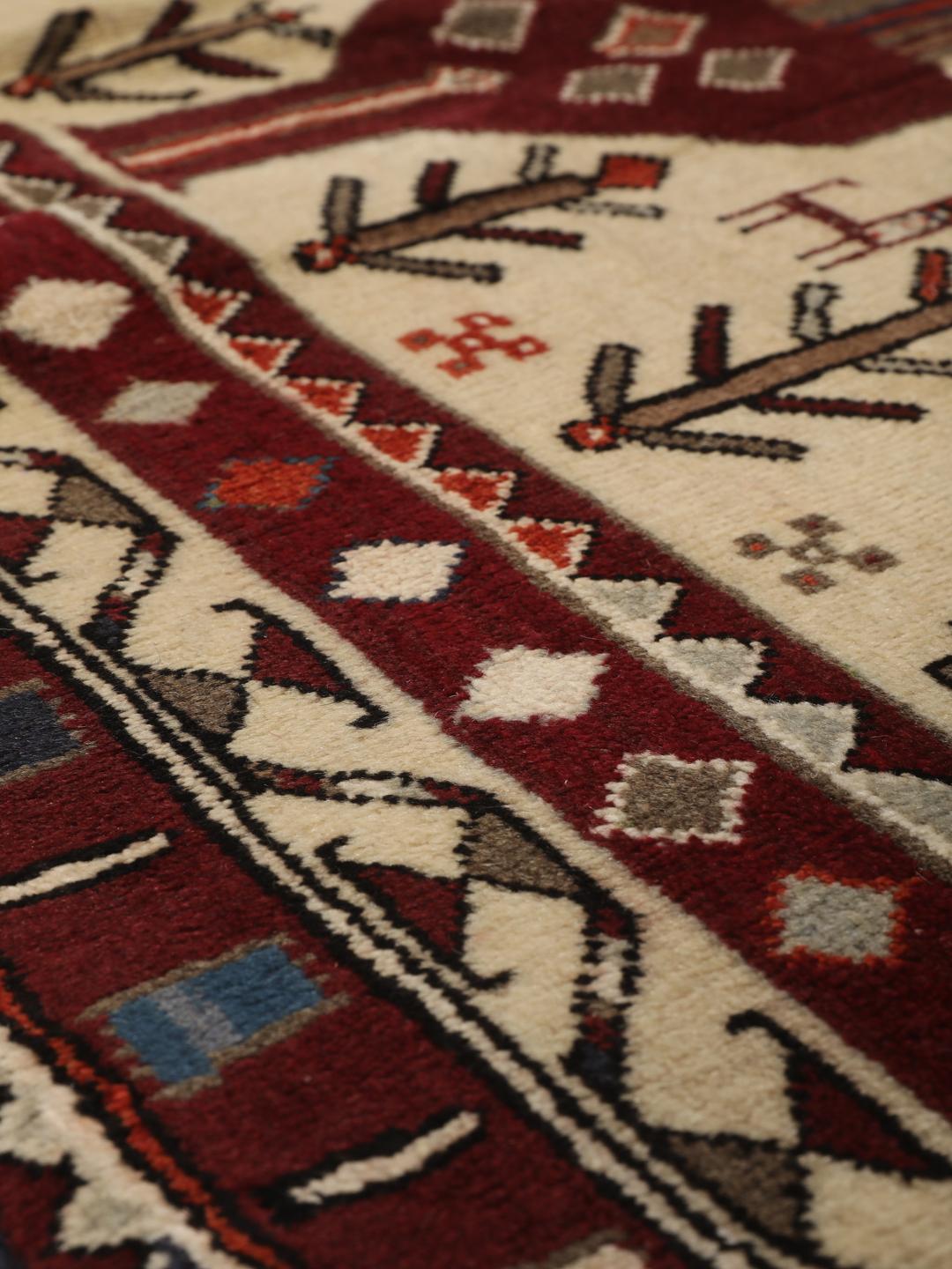 Hand-knotted Afshar rug from the Middle East in red and cream featuring pictorial motifs