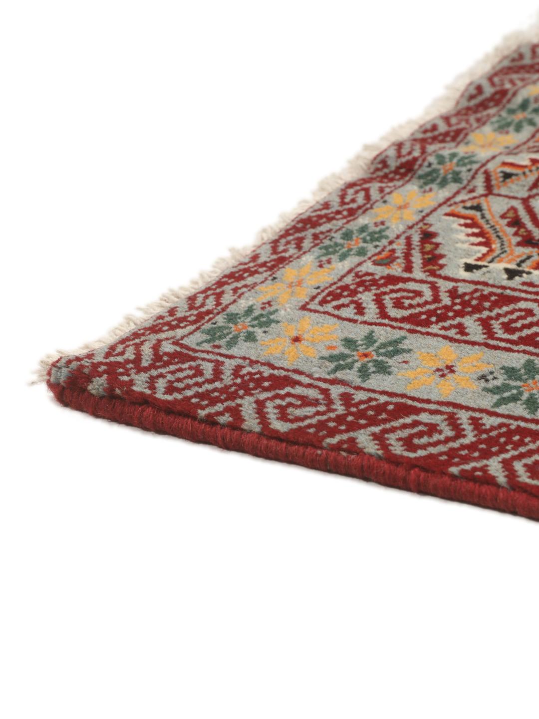 Hand-knotted Baluch rug with geometric patterns in red and grey from the Middle East