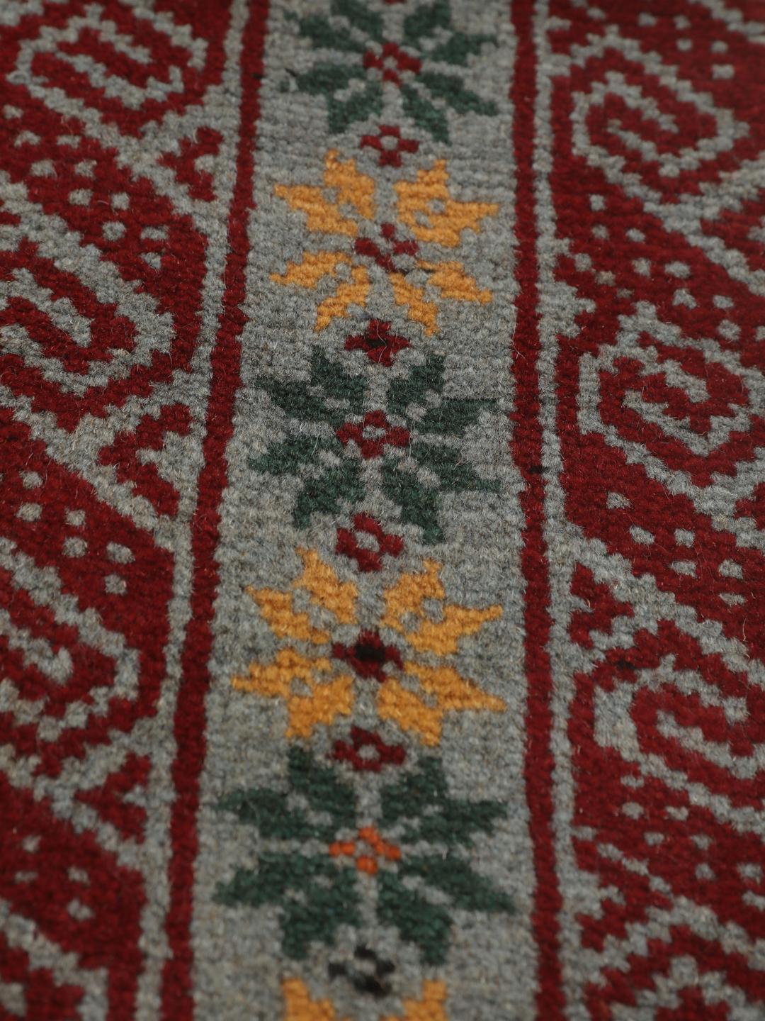 Hand-knotted Baluch rug with geometric patterns in red and grey from the Middle East