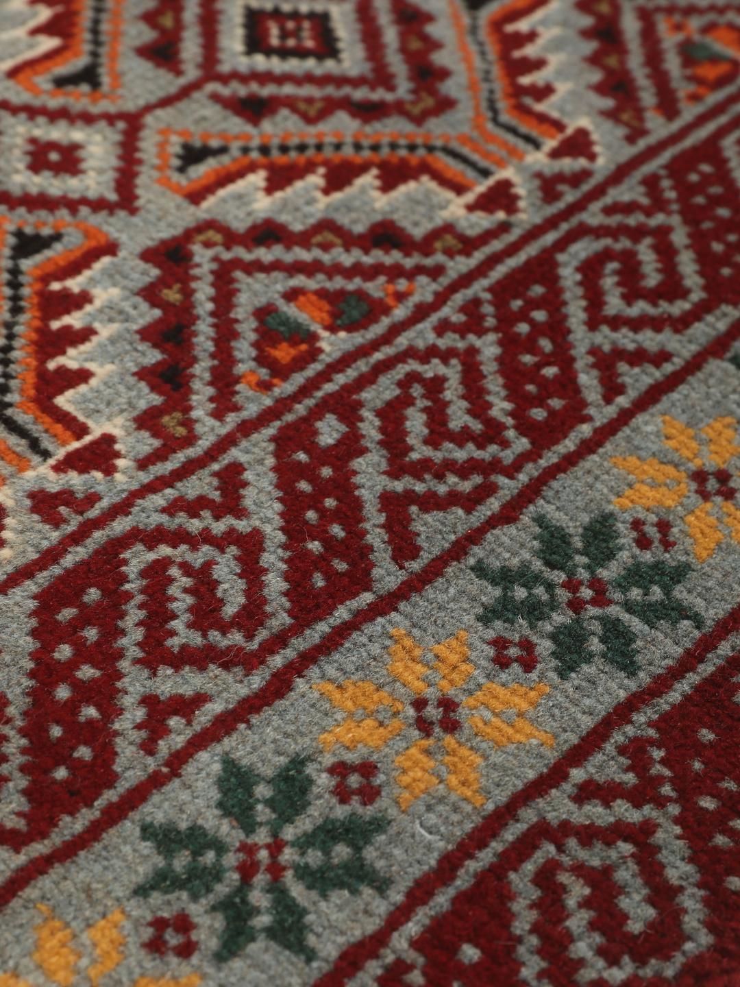 Hand-knotted Baluch rug with geometric patterns in red and grey from the Middle East