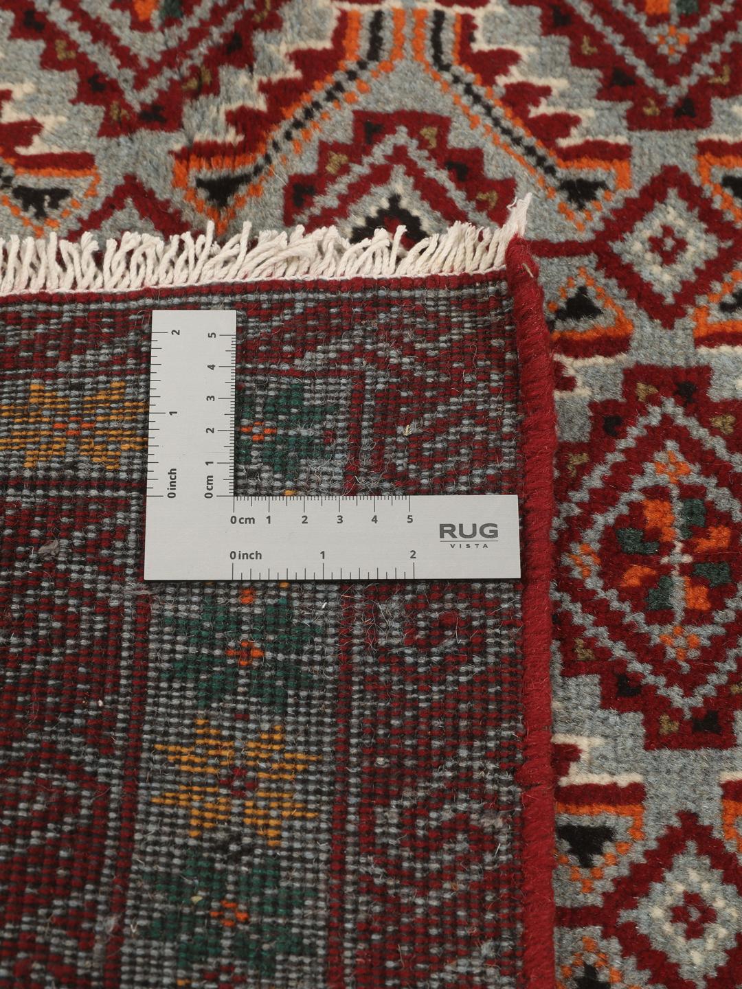 Hand-knotted Baluch rug with geometric patterns in red and grey from the Middle East