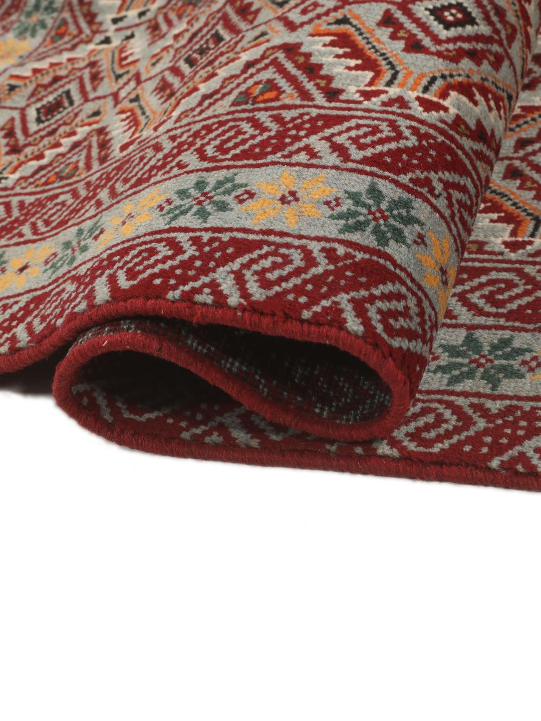 Hand-knotted Baluch rug with geometric patterns in red and grey from the Middle East