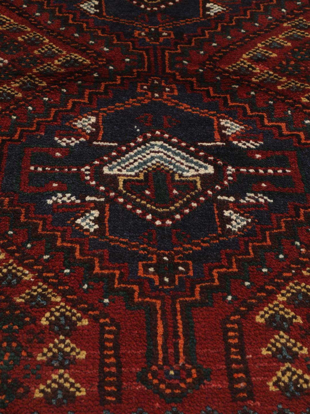 Hand-knotted Shiraz rug from the Middle East in deep red and blue tones