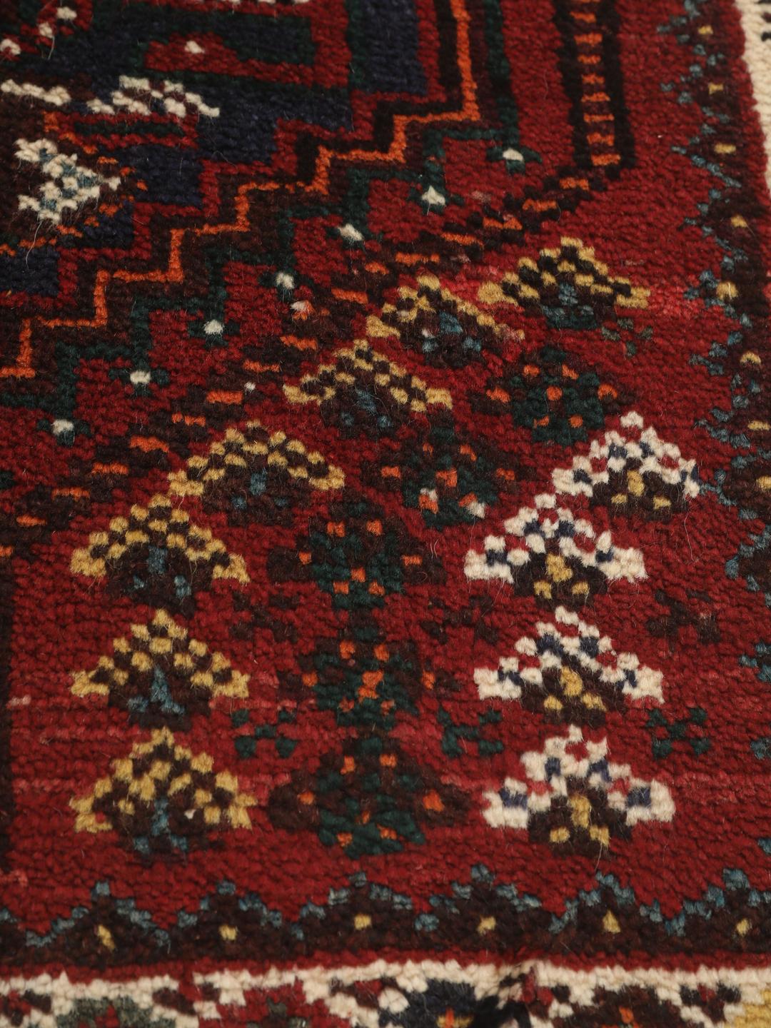 Hand-knotted Shiraz rug from the Middle East in deep red and blue tones