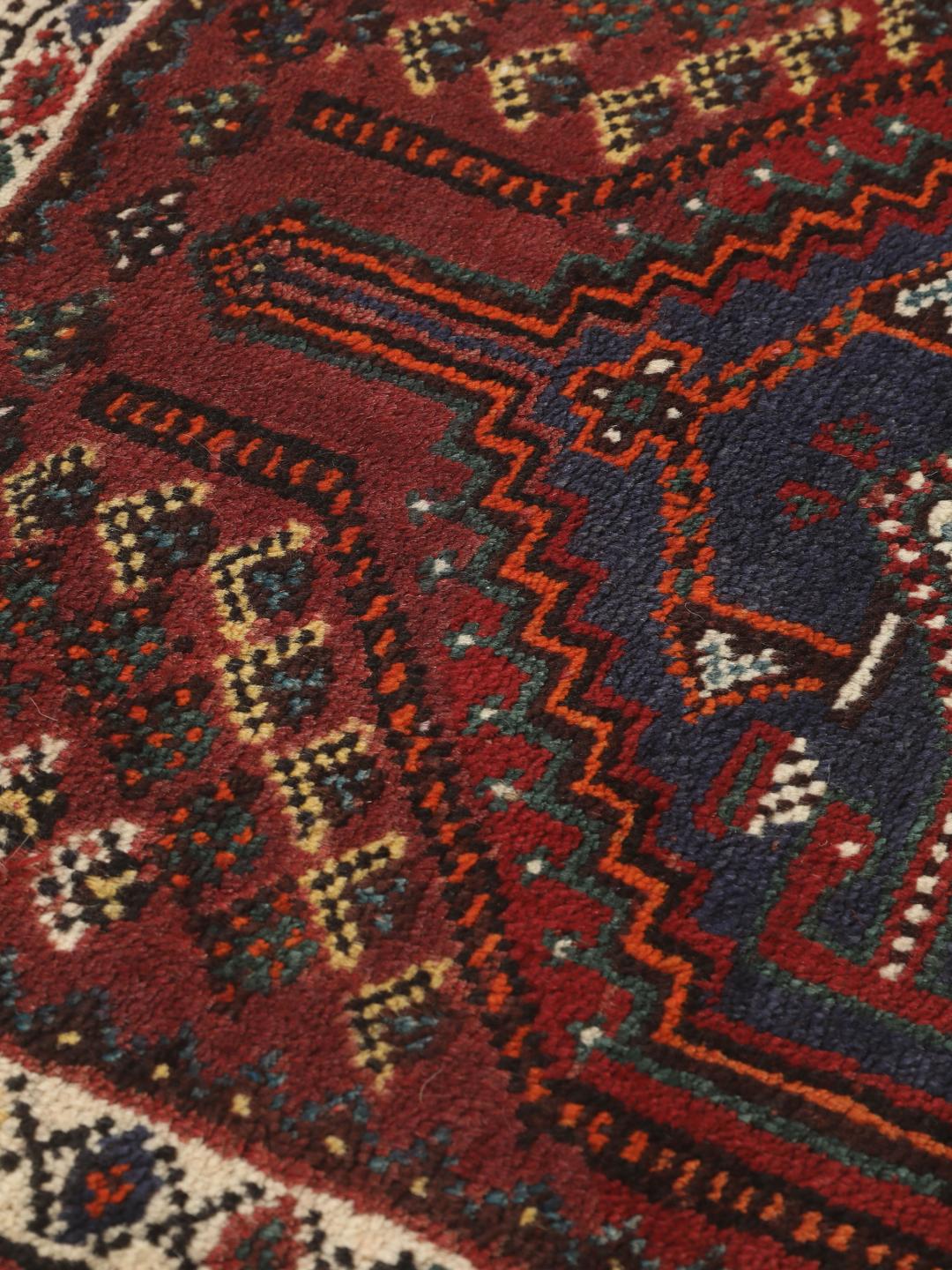 Hand-knotted Shiraz rug from the Middle East in deep red and blue tones