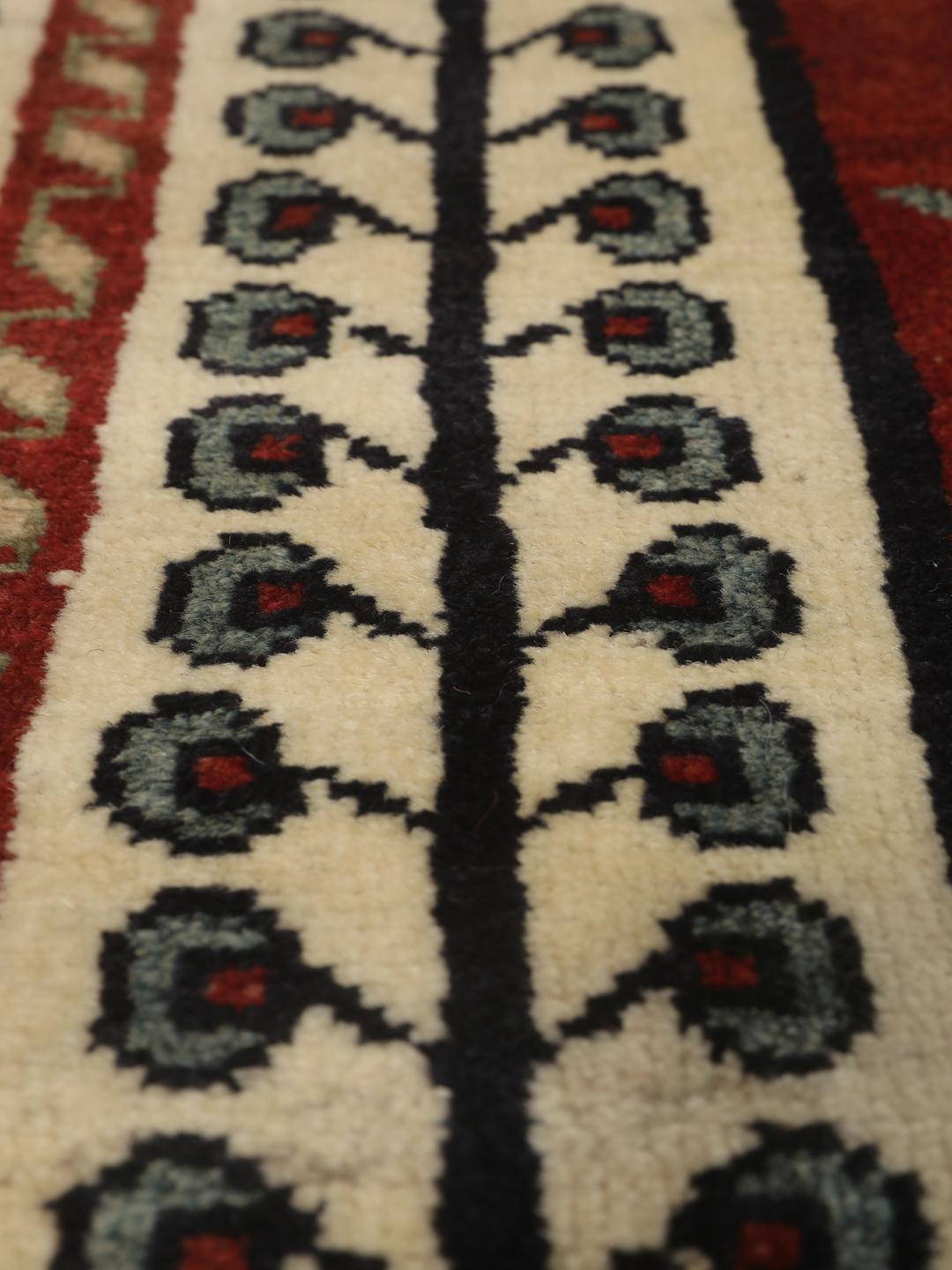 Hand-knotted Ghashghai rug from the Middle East featuring a vibrant red field with geometric diamond motifs.