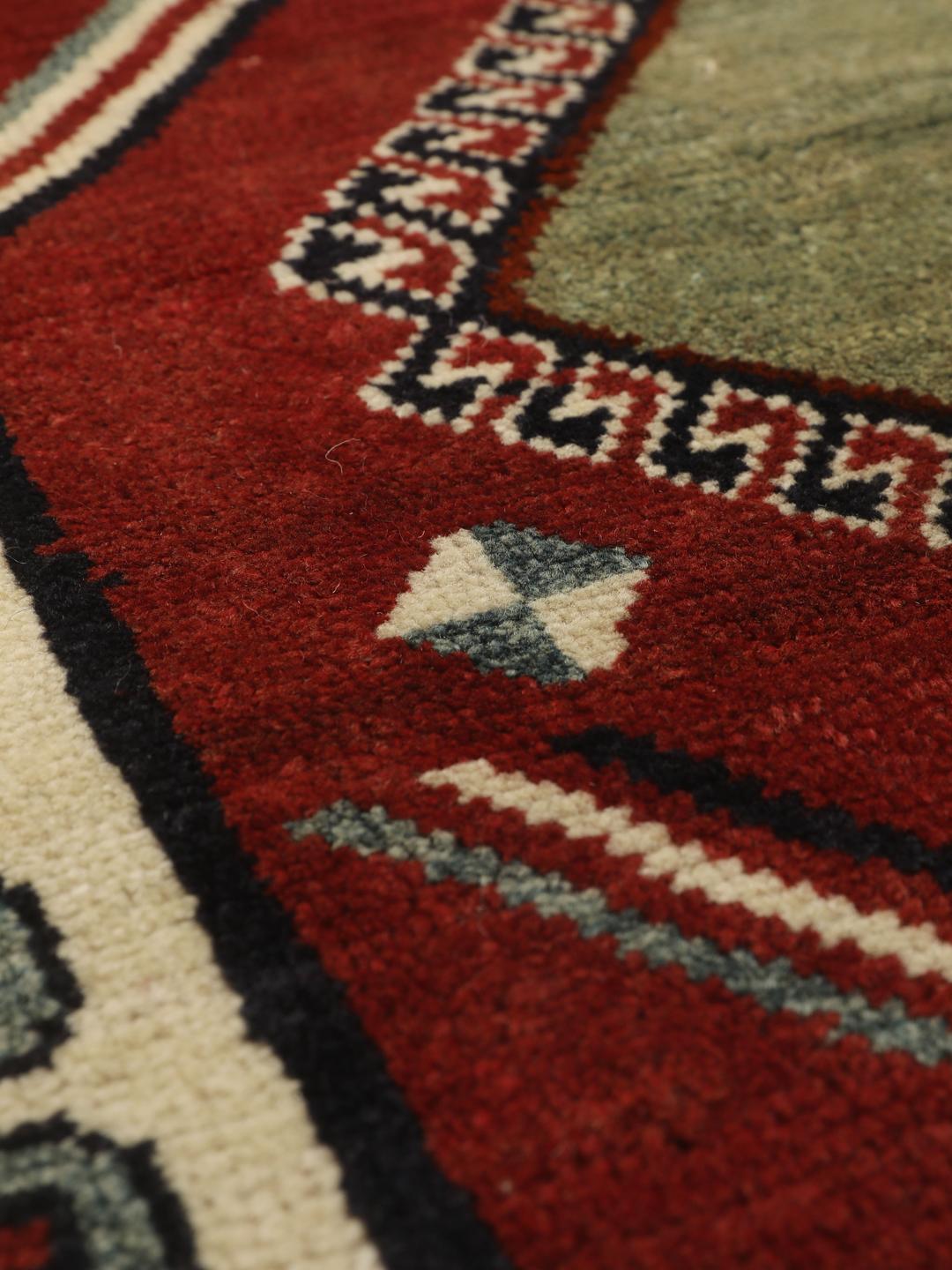 Hand-knotted Ghashghai rug from the Middle East featuring a vibrant red field with geometric diamond motifs.
