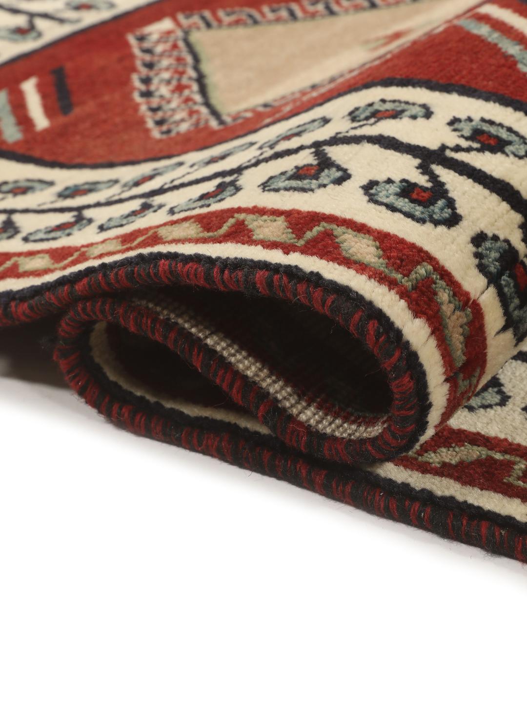 Hand-knotted Ghashghai rug from the Middle East featuring a vibrant red field with geometric diamond motifs.