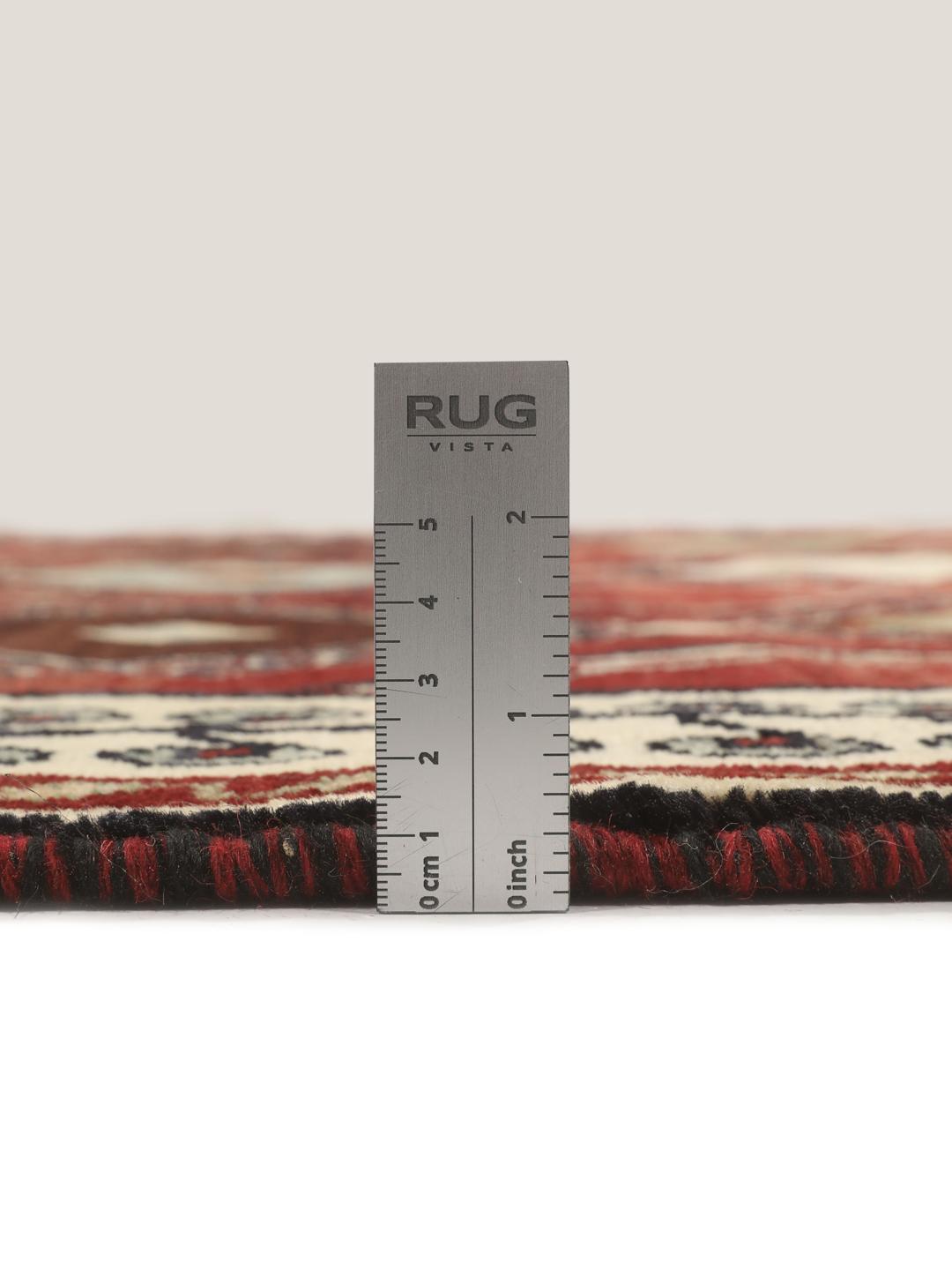 Hand-knotted Ghashghai rug from the Middle East featuring a vibrant red field with geometric diamond motifs.