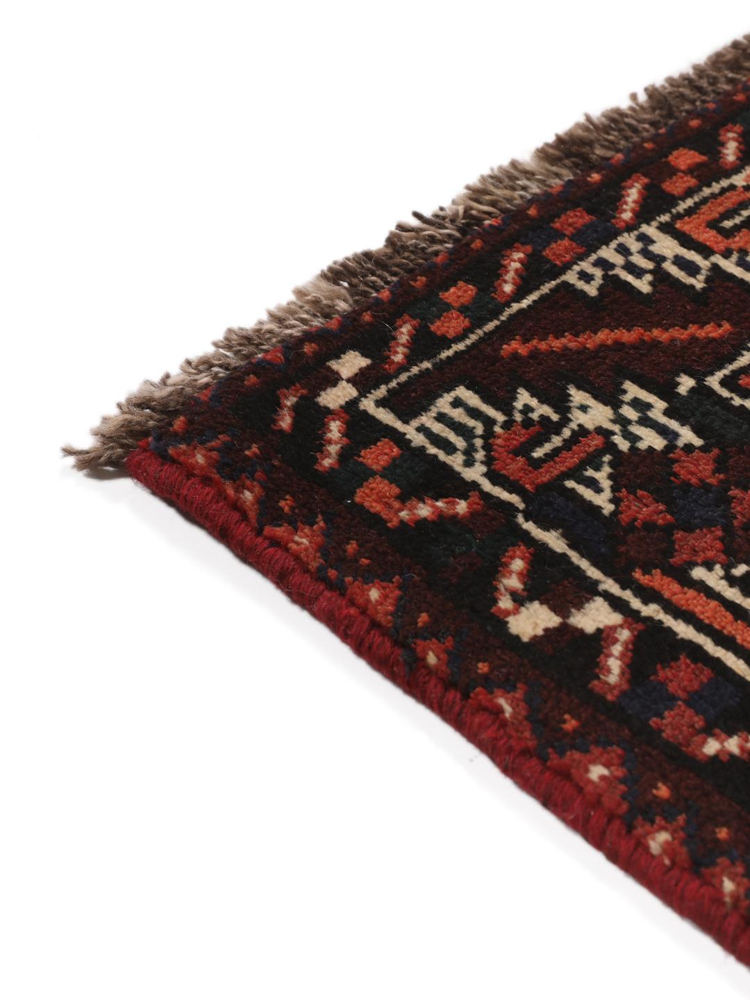 A hand-knotted Shiraz rug from the Middle East in dark-red and dark-blue tones.