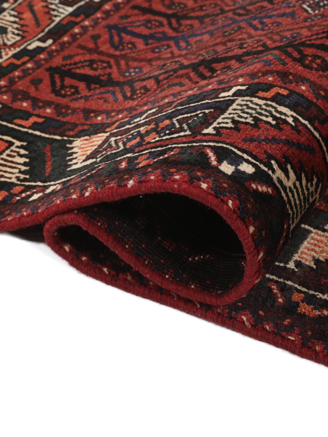 A hand-knotted Shiraz rug from the Middle East in dark-red and dark-blue tones.