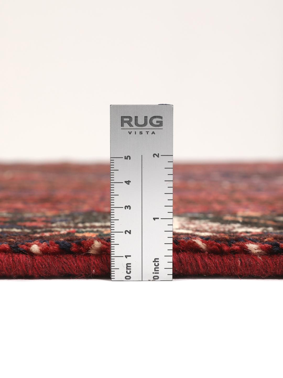 A hand-knotted Shiraz rug from the Middle East in dark-red and dark-blue tones.