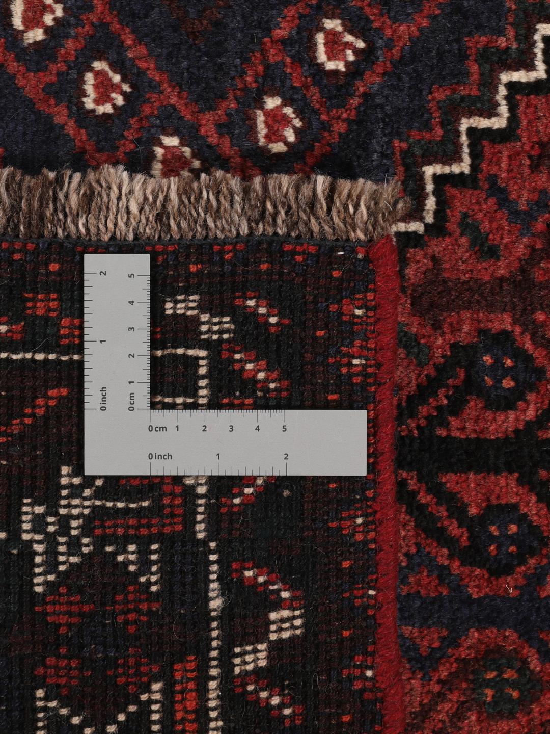A hand-knotted Shiraz rug from the Middle East in dark-red and dark-blue tones.