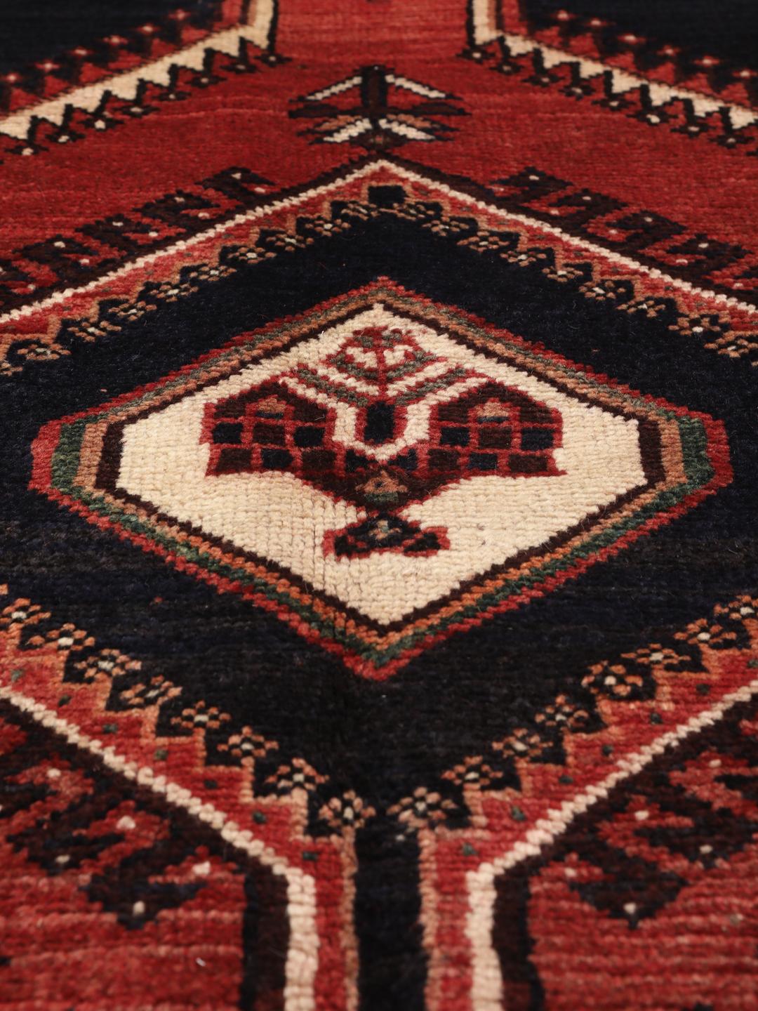 Hand-knotted wool rug from the Middle East in red and blue