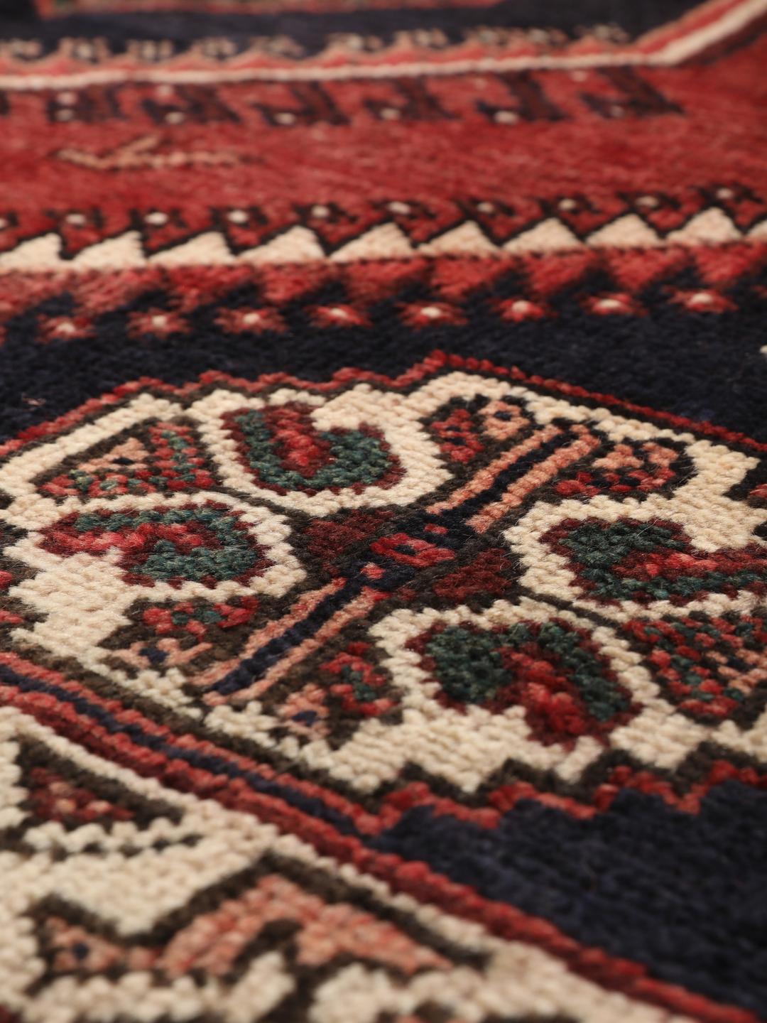 Hand-knotted wool rug from the Middle East in red and blue
