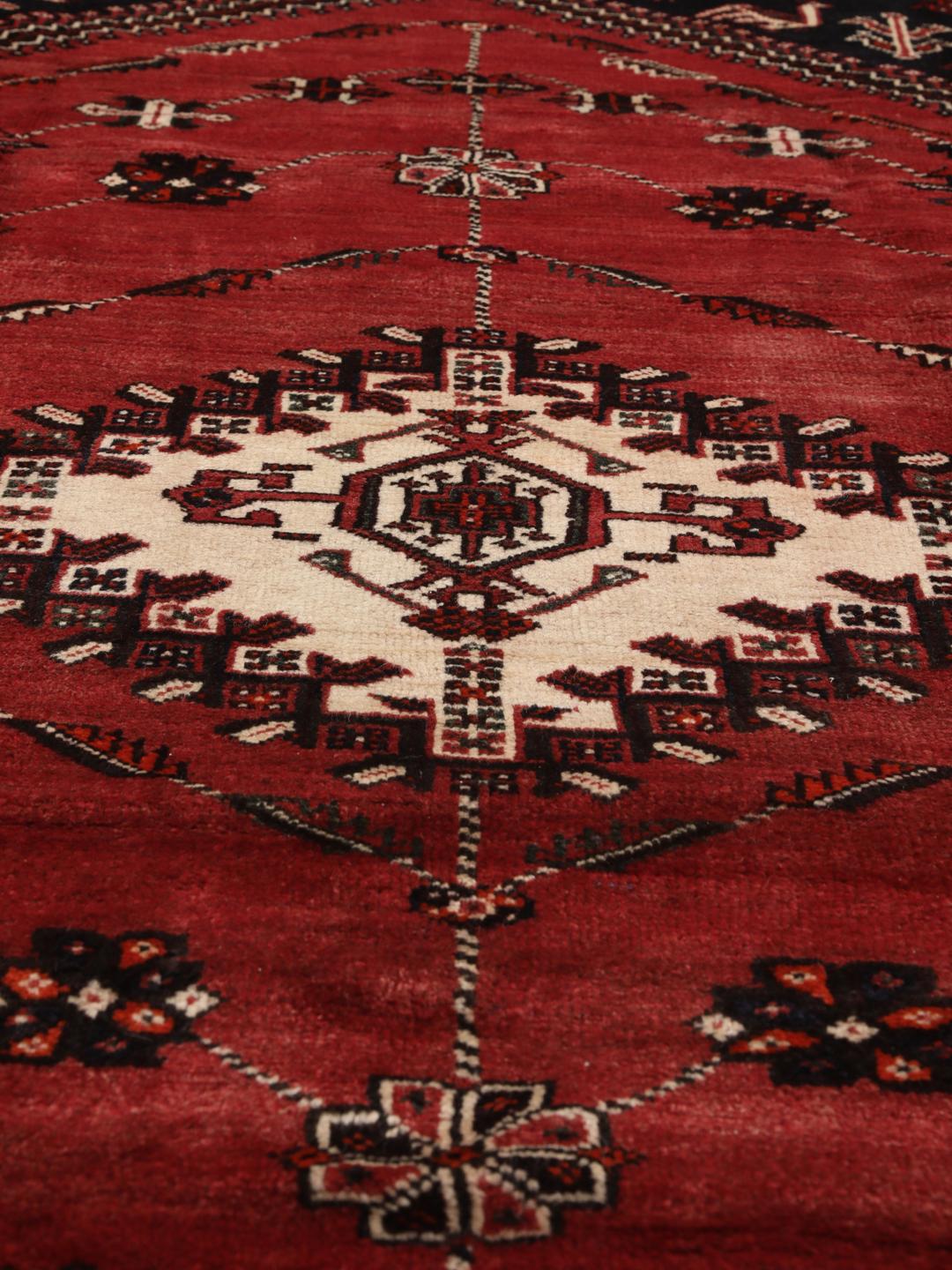 Hand-knotted Middle Eastern rug in red and black wool