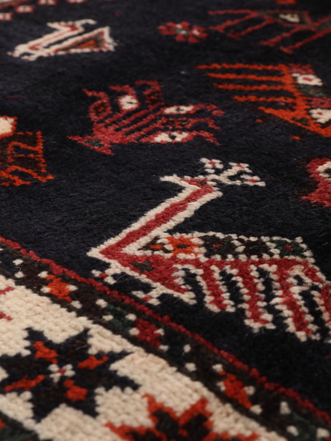 Hand-knotted Middle Eastern rug in red and black wool