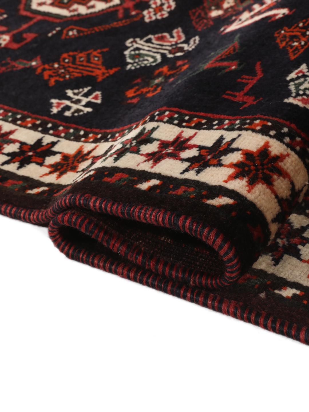 Hand-knotted Middle Eastern rug in red and black wool