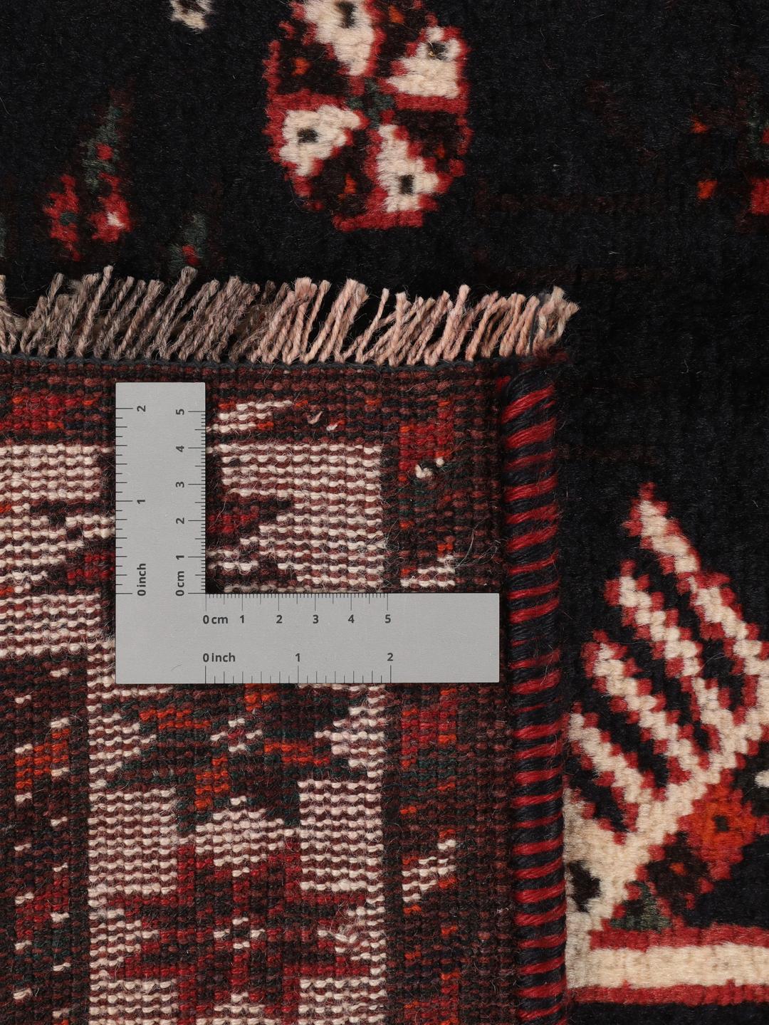 Hand-knotted Middle Eastern rug in red and black wool