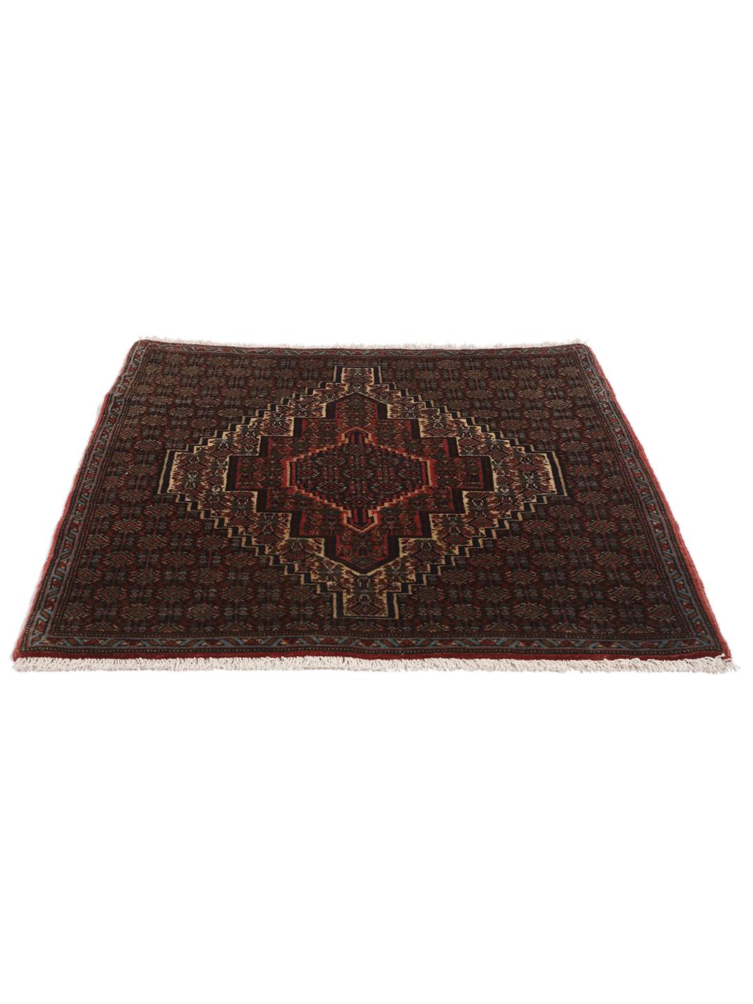 A hand-knotted Senneh rug from the Middle East in dark-red and dark-blue tones.